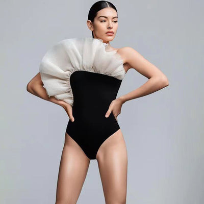 Black one-piece swimsuit with a large 3D flower on one shoulder and a geometric pattern on the bodice. - Image 39