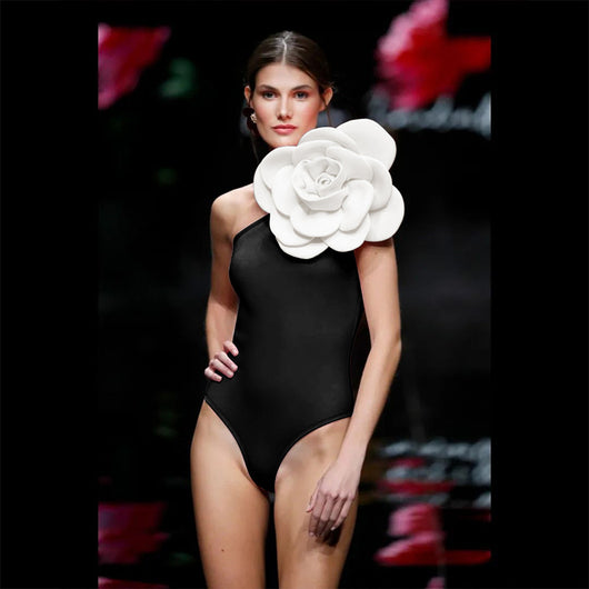 Black one-piece swimsuit with a large 3D flower on one shoulder and a geometric pattern on the bodice. - Image 40