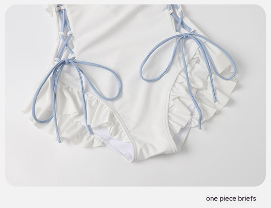 Women's white one-piece swimsuit with light blue lace-up sides, ruffled straps, and pearl-like buttons. - Image 28