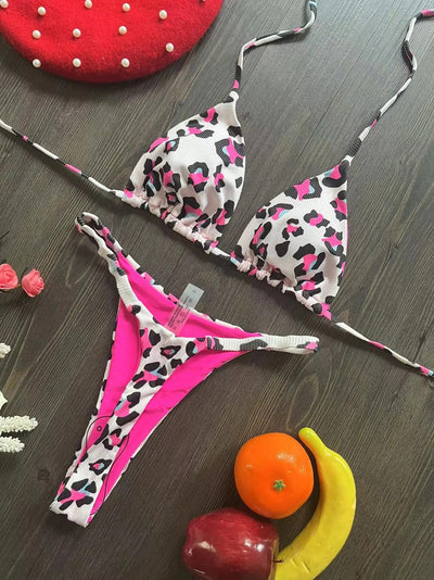 White textured bikini with red cherry print, featuring a triangle top and tie-side bottoms, on a woven mat. - Image 15
