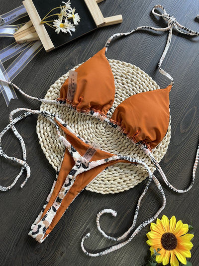 White textured bikini with red cherry print, featuring a triangle top and tie-side bottoms, on a woven mat. - Image 20