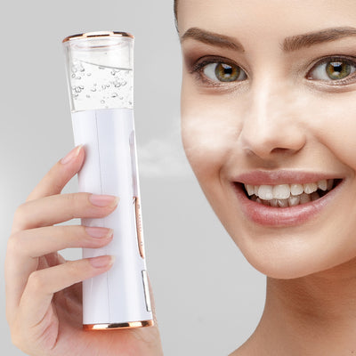 White and rose gold double-spraying nano mist sprayer with a clear reservoir, next to its product box and USB cable. - Image 17