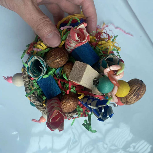 Colorful hanging bird toy with a woven grass basket, wooden beads, paper tubes, and shredded paper for parrots. - Image 9
