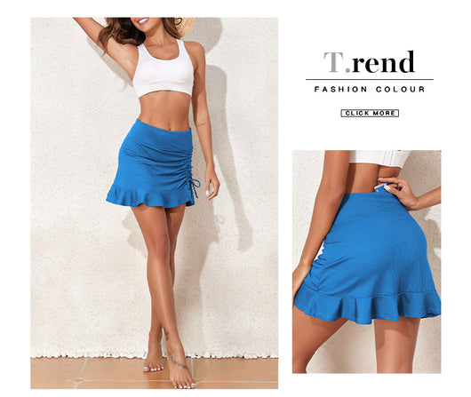 White ribbed high-waisted skort with a pleated skirt overlay, ruched side with drawstrings, and a ruffled hem. - Image 28