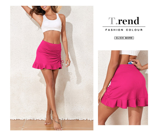White ribbed high-waisted skort with a pleated skirt overlay, ruched side with drawstrings, and a ruffled hem. - Image 29