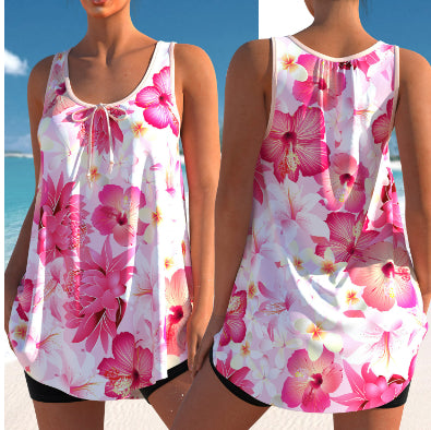 Woman wearing a pink and white floral print tankini top with black swim shorts on a sunny beach. - Image 10