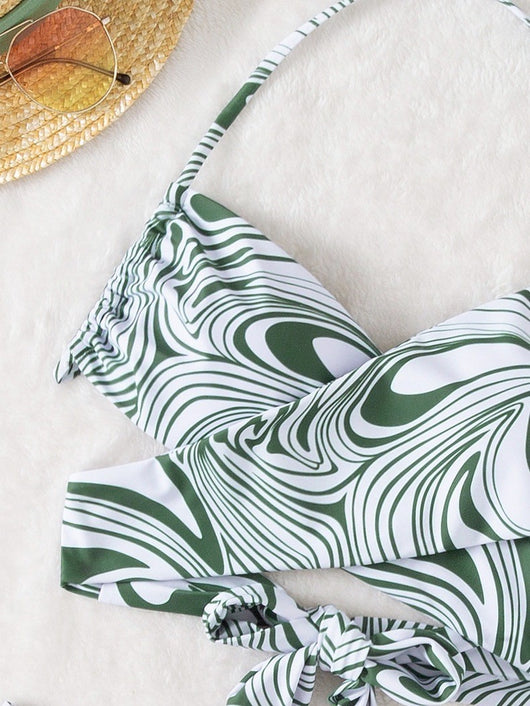 Green and white abstract swirl print halter bikini with a cross-front top and high-cut bottoms with an O-ring. - Image 8