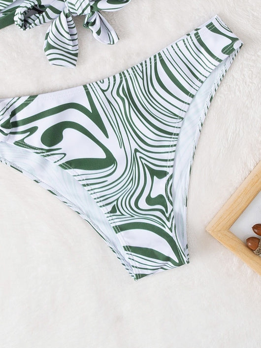 Green and white abstract swirl print halter bikini with a cross-front top and high-cut bottoms with an O-ring. - Image 13