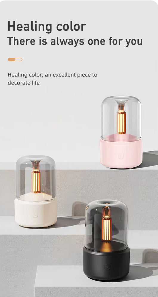 White cylindrical aroma diffuser with a clear top and an amber candlelight-effect LED light. - Image 18