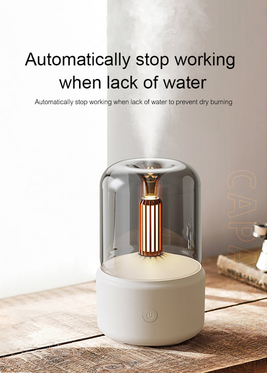 White cylindrical aroma diffuser with a clear top and an amber candlelight-effect LED light. - Image 22