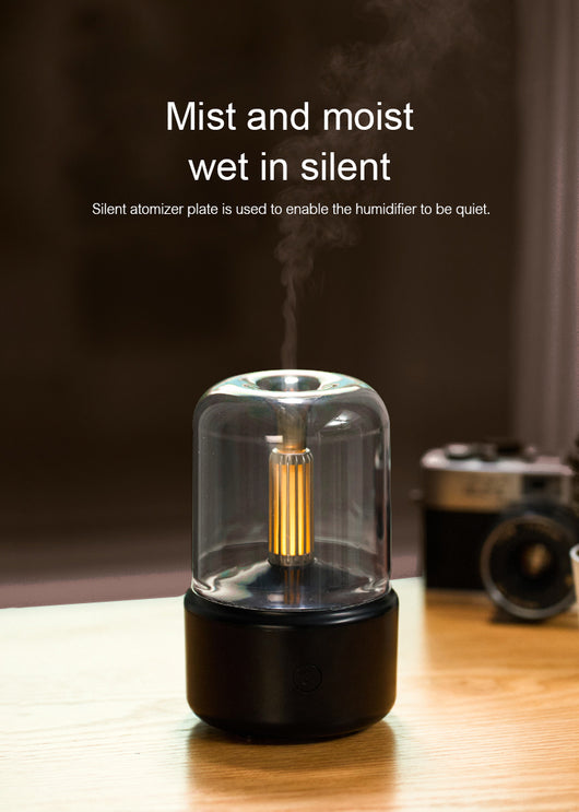 White cylindrical aroma diffuser with a clear top and an amber candlelight-effect LED light. - Image 24
