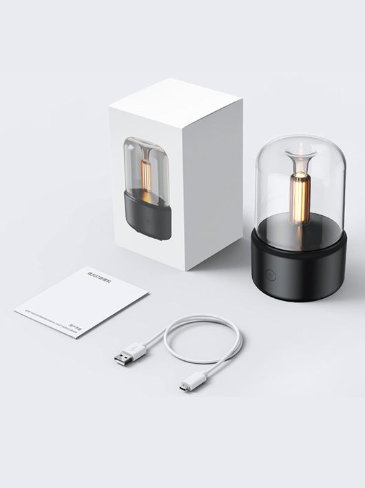 White cylindrical aroma diffuser with a clear top and an amber candlelight-effect LED light. - Image 25