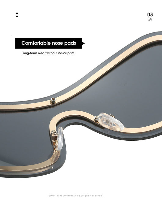Women's fashionable shield sunglasses with a gold metal frame and dark gray lenses, featuring a unique wavy design. - Image 25
