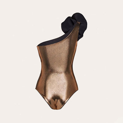 Metallic bronze one-piece swimsuit with a one-shoulder design, large decorative flower, and side cut-out revealing a black panel. - Image 21