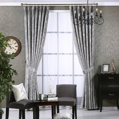 Gray chenille blackout curtains with a subtle silver geometric pattern, hung on a gold rod in a modern living room. - Image 9
