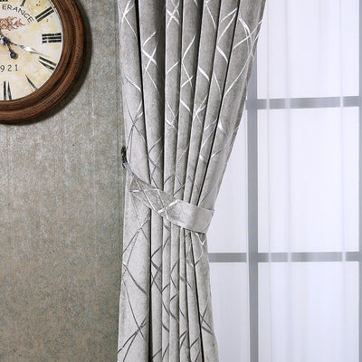 Gray chenille blackout curtains with a subtle silver geometric pattern, hung on a gold rod in a modern living room. - Image 12
