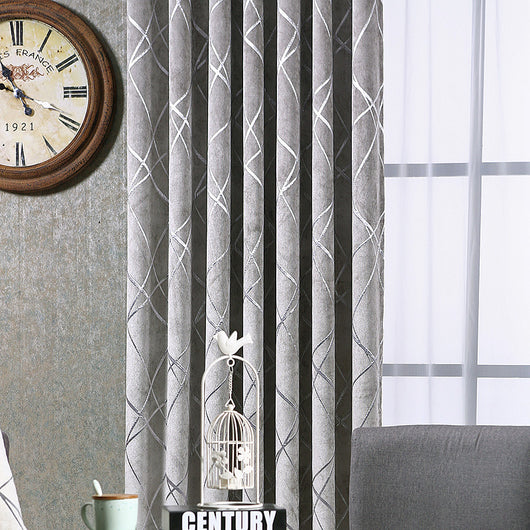 Gray chenille blackout curtains with a subtle silver geometric pattern, hung on a gold rod in a modern living room. - Image 13