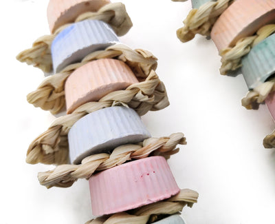 Colorful bird toy with stacked ridged blocks, natural straw, a wooden perch, and a golden bell, hanging from a metal clip. - Image 9