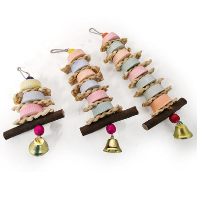 Colorful bird toy with stacked ridged blocks, natural straw, a wooden perch, and a golden bell, hanging from a metal clip. - Image 11