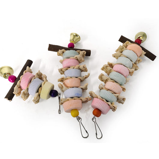 Colorful bird toy with stacked ridged blocks, natural straw, a wooden perch, and a golden bell, hanging from a metal clip. - Image 14