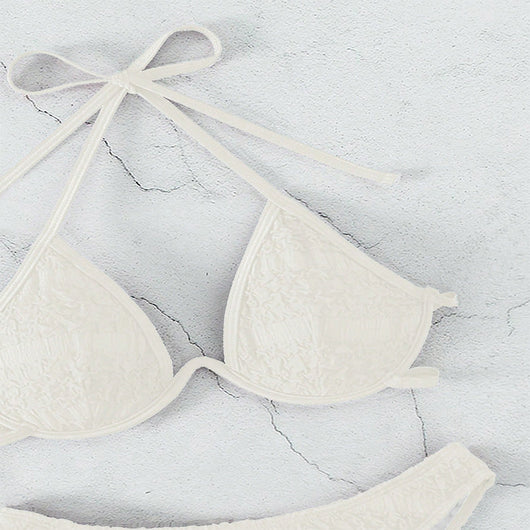 Woman in a white halter lace-up bikini with textured fabric, U-wire top, and high-cut bottom by a pool. - Image 21