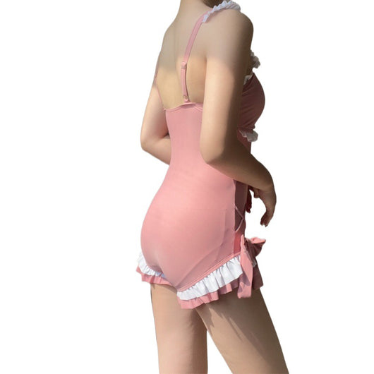 Pink one-piece swimming suit with white ruffles, ruched bust, pearl buttons, and shorts-style bottom with side ties. - Image 17