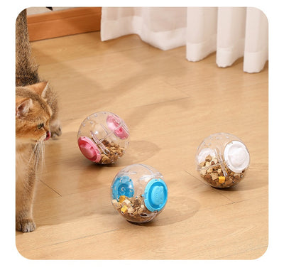 Clear plastic pet tumbler food leakage toy with blue accents and a cat face design, on a wooden floor. - Image 20