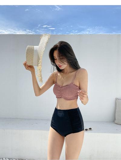 Women's retro high-waisted split bikini with a pink shirred bandeau top and black ruched bottoms. - Image 30