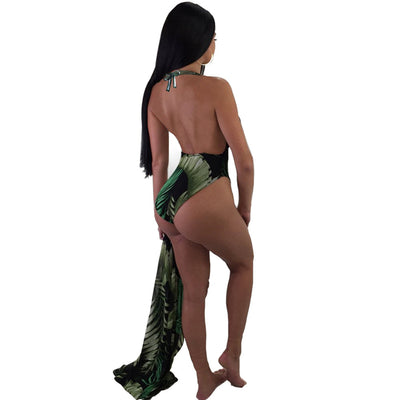 Woman in a black one-piece swimsuit with green leaf print, plunging V-neck, and matching sheer sarong cover-up. - Image 5