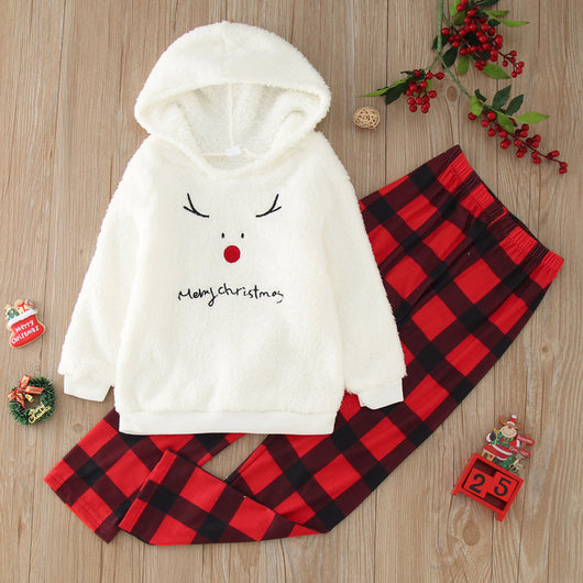 Family of four wearing matching cream fleece reindeer pajamas with red plaid pants, posing for a Christmas photo. - Image 10