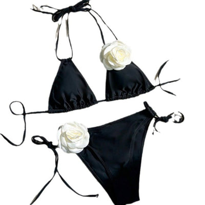 Black two-piece bikini with white 3D flower embellishments on the triangle top and tie-side bottom. - Image 15