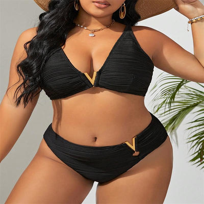 Plus size woman in a black textured two-piece bikini with gold V-shaped hardware. The top is a plunge style, and the bottoms are high-waisted. - Image 14