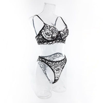 Black embroidered lace bra and thong set with transparent design and steel ring, displayed on white fabric. - Image 20
