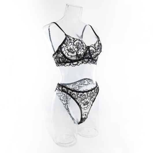 Black embroidered lace bra and thong set with transparent design and steel ring, displayed on white fabric. - Image 20