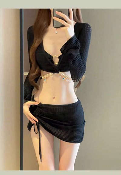 White three-piece bikini swimsuit set with a long-sleeve crop top, bikini top with gold ring, and ruched mini skirt. - Image 22