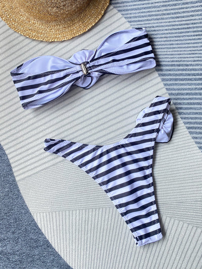 Black tube top bikini with white three-dimensional flower embellishments, worn by a woman partially submerged in water. - Image 30