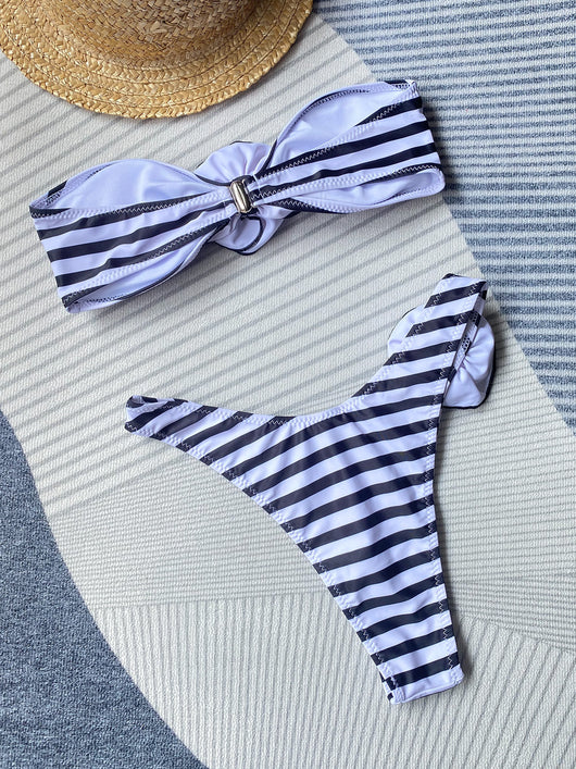 Black tube top bikini with white three-dimensional flower embellishments, worn by a woman partially submerged in water. - Image 30