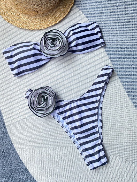 Black tube top bikini with white three-dimensional flower embellishments, worn by a woman partially submerged in water. - Image 31