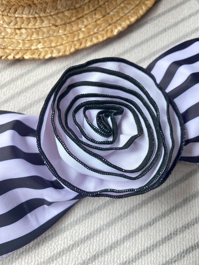 Black tube top bikini with white three-dimensional flower embellishments, worn by a woman partially submerged in water. - Image 35