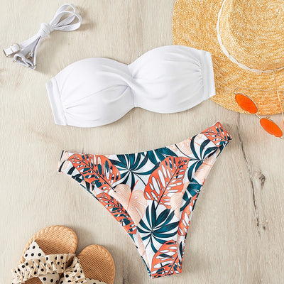 Blue bandeau bikini top with tropical leaf print high-cut bottom, styled with sandals, sunglasses, and a straw hat. - Image 22