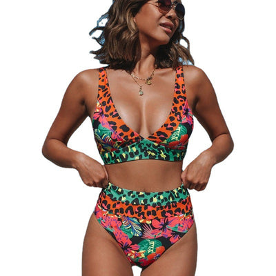 Women's high-waisted bikini with a vibrant floral and leopard print in blue, orange, and green, at the beach. - Image 20
