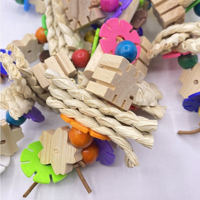Colorful parrot gnawing toy with wooden blocks, woven straw, and plastic beads, hanging from a metal hook. - Image 10