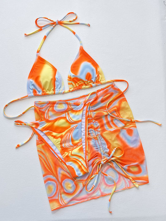 Women's three-piece swimsuit with orange, yellow, and blue abstract swirl pattern. Includes a triangle bikini top, tie-side bottom, and matching ruched sarong s - Image 15