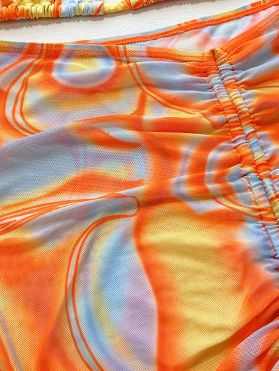 Women's three-piece swimsuit with orange, yellow, and blue abstract swirl pattern. Includes a triangle bikini top, tie-side bottom, and matching ruched sarong s - Image 18