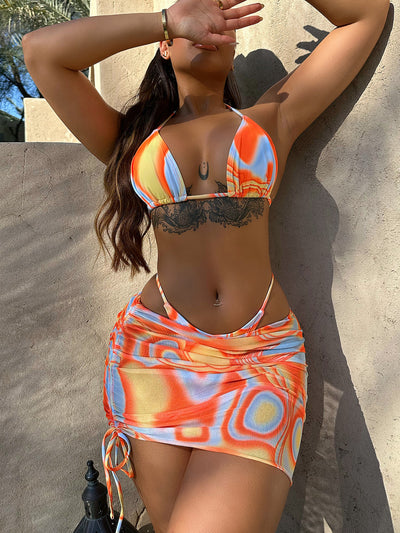 Women's three-piece swimsuit with orange, yellow, and blue abstract swirl pattern. Includes a triangle bikini top, tie-side bottom, and matching ruched sarong s - Image 20