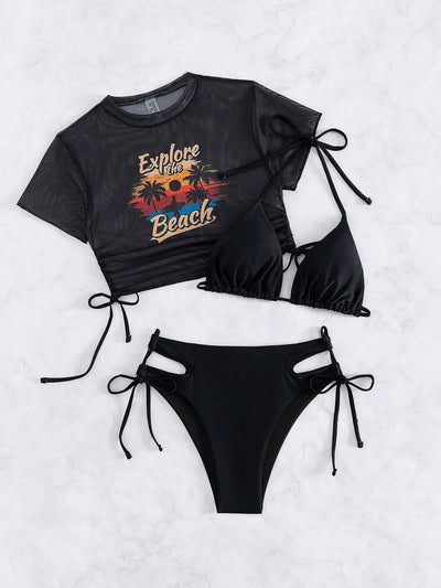 Black three-piece swimsuit with a mesh crop top featuring an "Explore the Beach" graphic, bikini top, and high-waisted bottoms. - Image 48