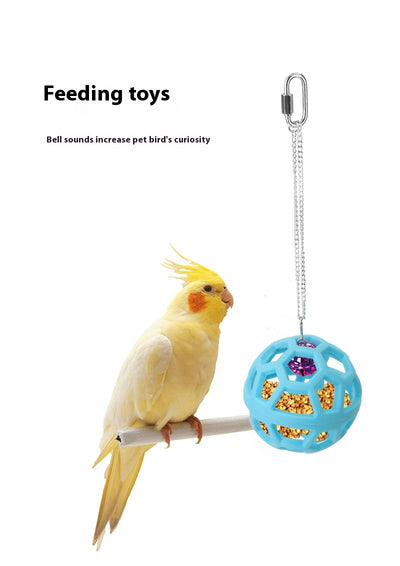 Orange hollow rubber ball bird toy with a pink bell inside, hanging from a silver chain and carabiner clip. - Image 13