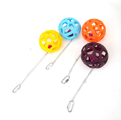 Orange hollow rubber ball bird toy with a pink bell inside, hanging from a silver chain and carabiner clip. - Image 16
