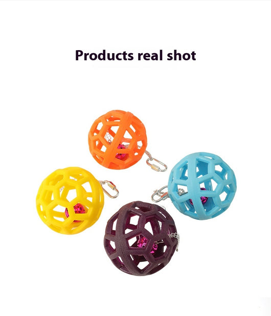 Orange hollow rubber ball bird toy with a pink bell inside, hanging from a silver chain and carabiner clip. - Image 17