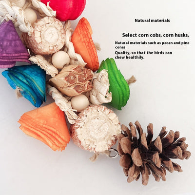 Blue parrot playing with a colorful natural material bird toy featuring corn cobs, wood, and pinecones, hanging in a white birdcage. - Image 15